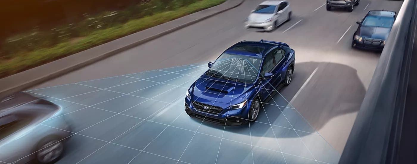 A blue 2023 Subaru WRX driving on a multi-lane highway with simulated sensor lines.
