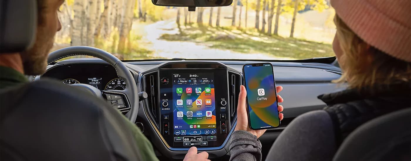 A person using Apple CarPlay on their phone in a 2024 Subaru Crosstrek.