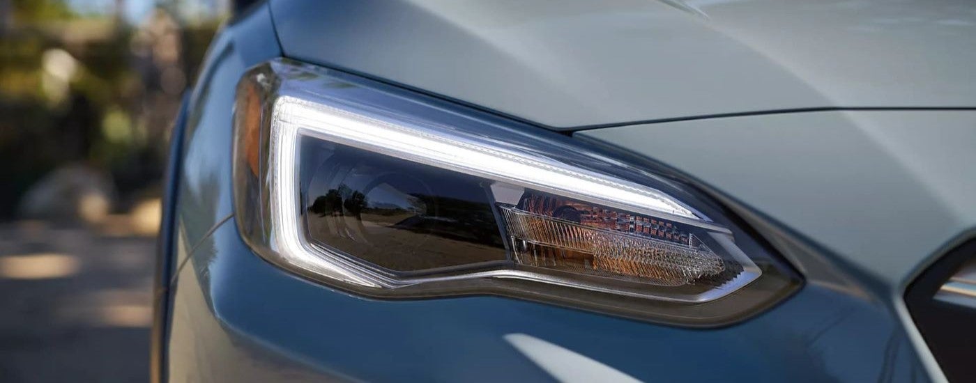 A close up shows the passenger side headlight on a gray 2023 Subaru Crosstrek.