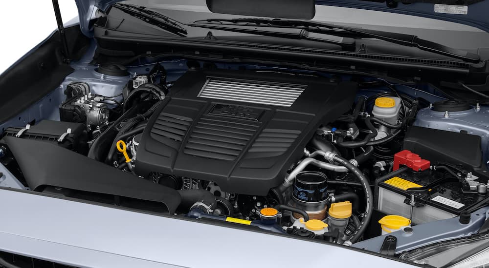 A close up showing the turbo charged boxer engine in a white 2016 Subaru WRX.
