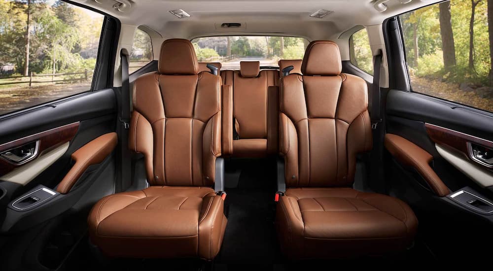 The brown interior of a 2022 Subaru Ascent Touring with two rows of seating.
