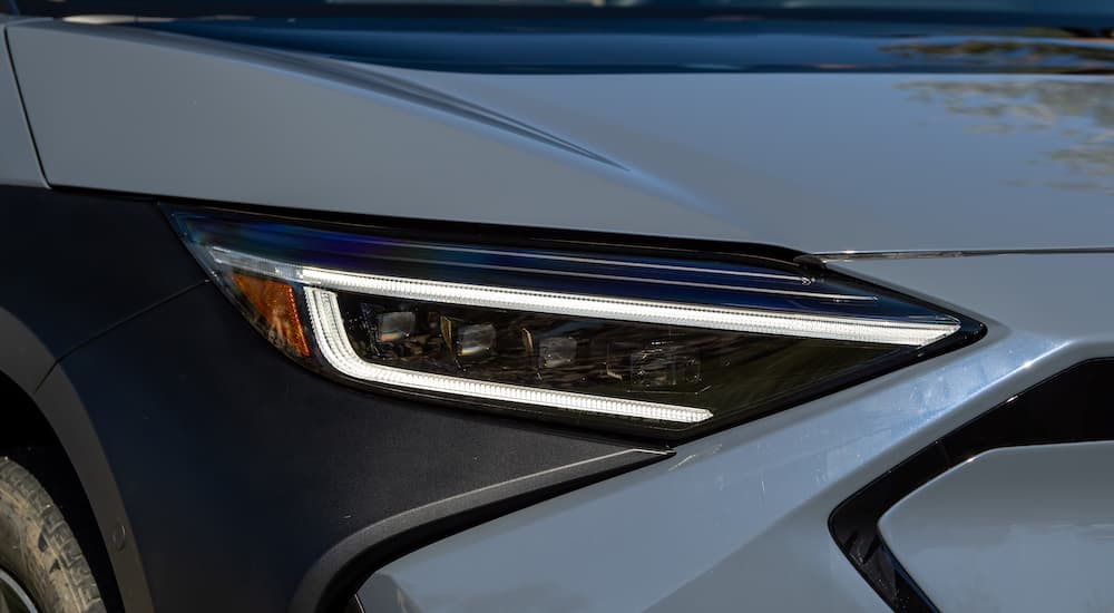 A close up shows the headlight on a blue 2023 Subaru Solterra.