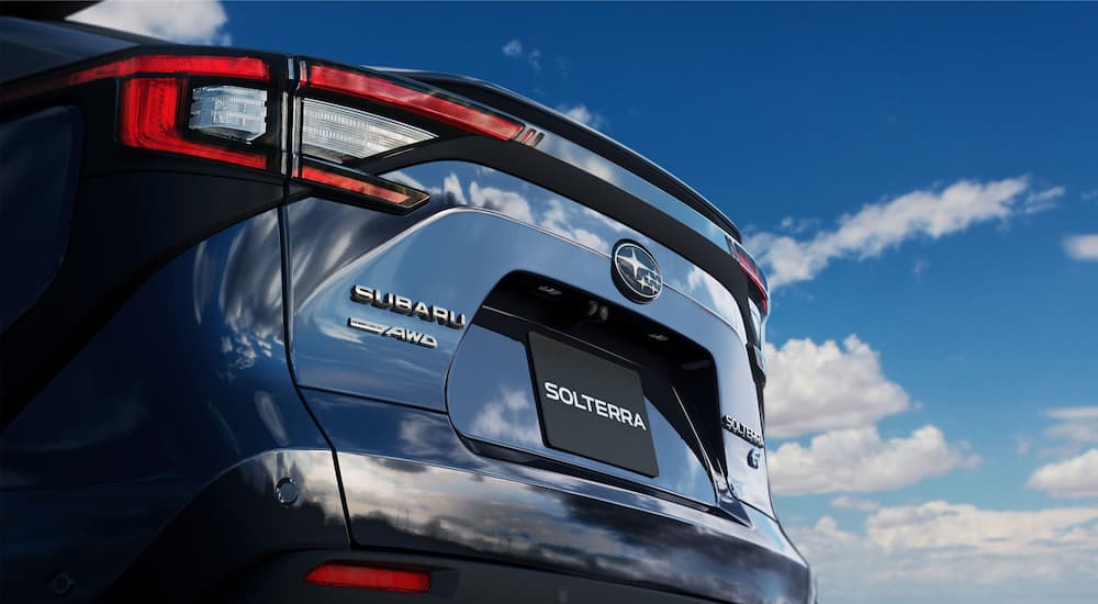 A close up shows the badging on the trunk of a blue 2023 Subaru Solterra.