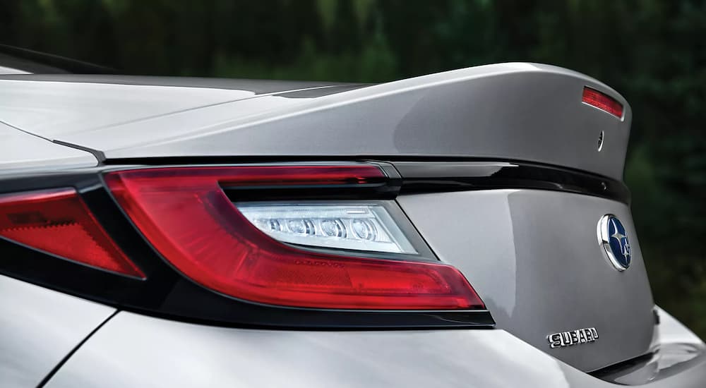 A close up shows the driver side taillight and spoiler on a silver 2023 Subaru BRZ.