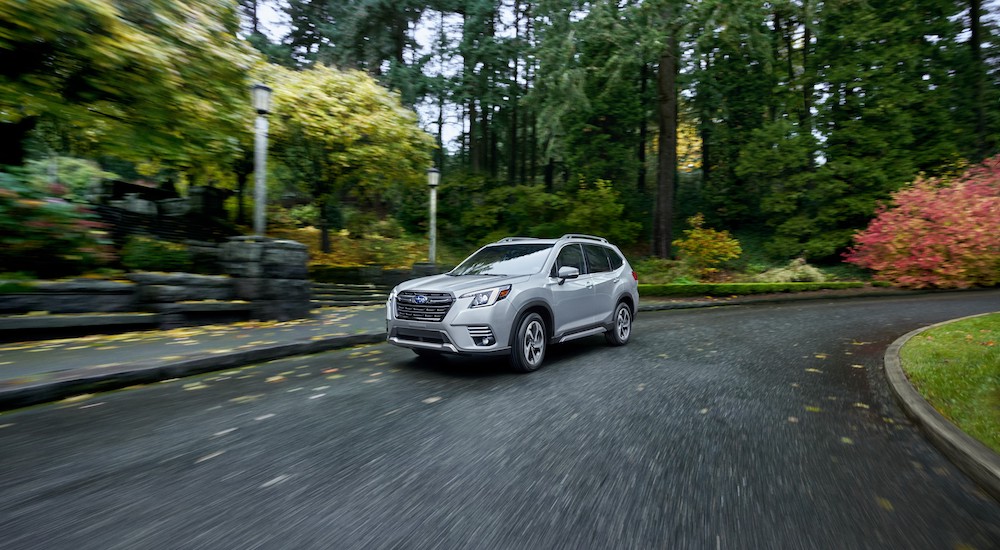 A silver 2022 Subaru Forester Touring is shown rounding a corner.