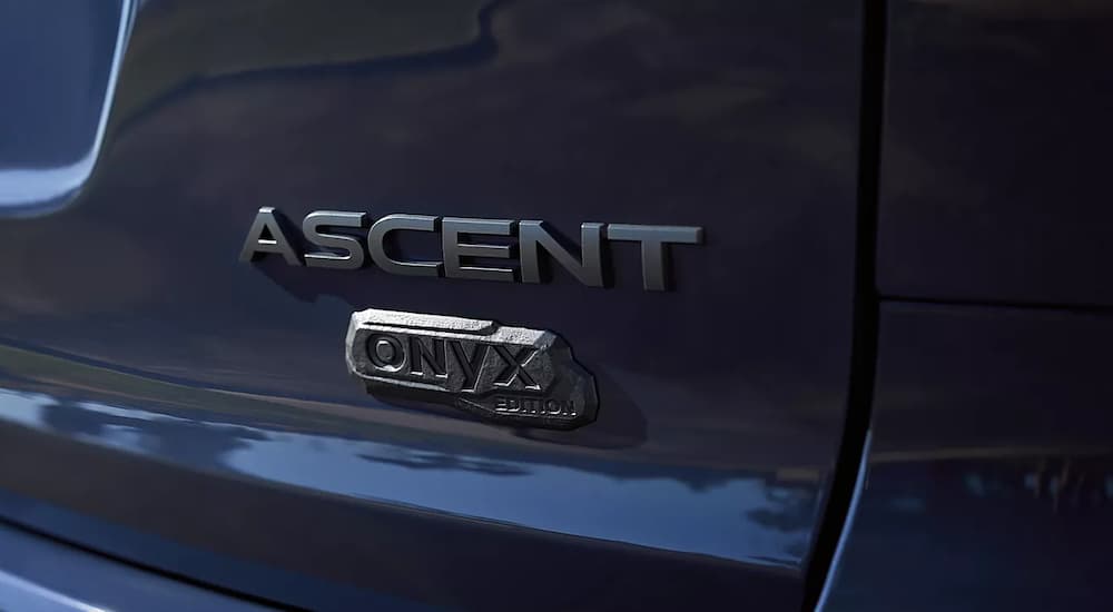 A close up shows a badge on the trunk of a dark blue 2023 Subaru Ascent Onyx Edition.