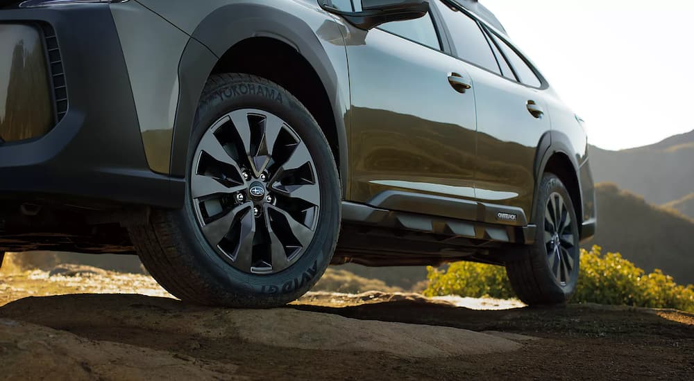 A close up shows the driver side wheels on a 2023 Subaru Outback XT Onyx Edition.