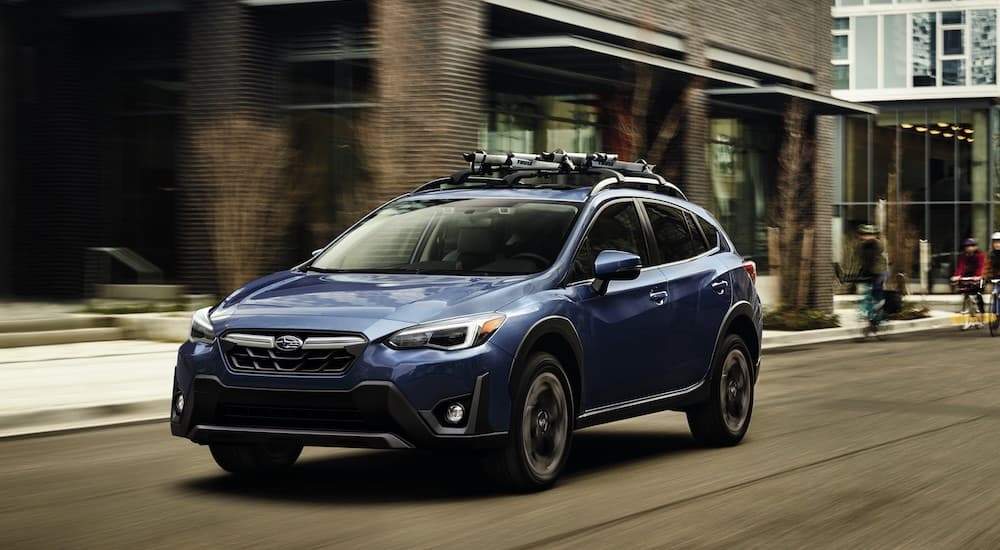 A blue 2023 Subaru Crosstrek is shown from the front at an angle after the owner searched for used Subarus for sale in Charlotte.