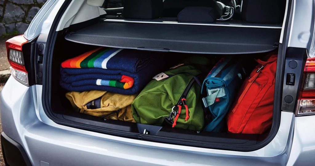 Luggage is show in the trunk of a silver 2023 Subaru Crosstrek.