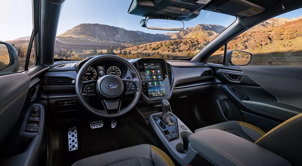 The black interior of a 2024 Subaru Crosstrek Wilderness is shown from the driver's seat.