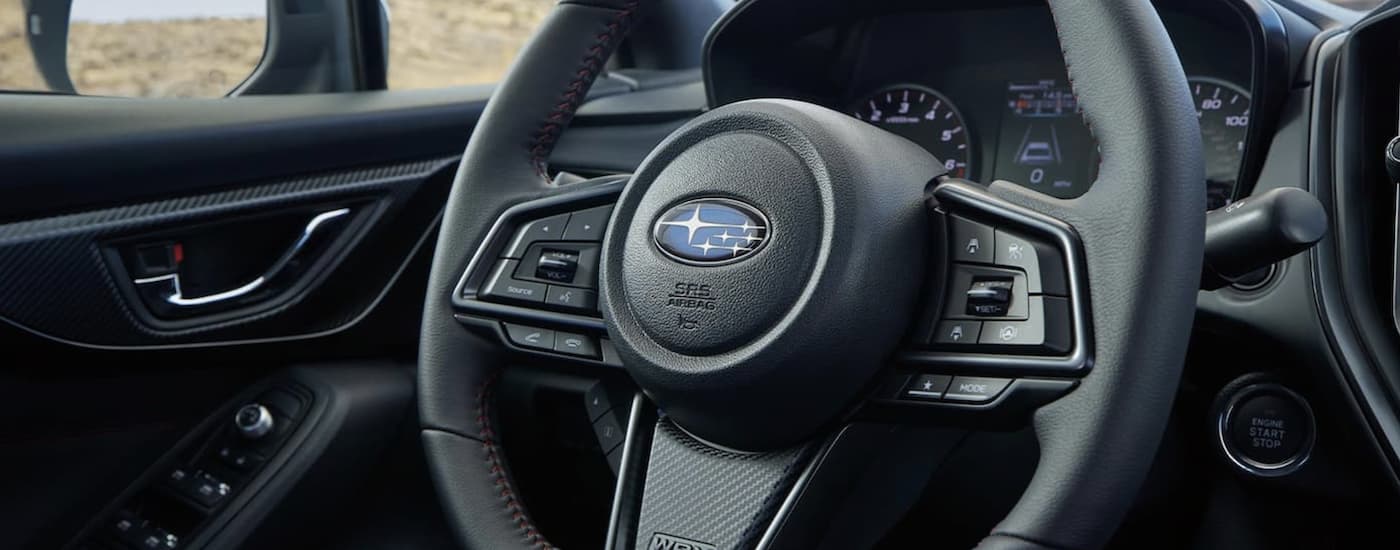 A close up of the steering wheel in a 2022 Subaru WRX is shown.