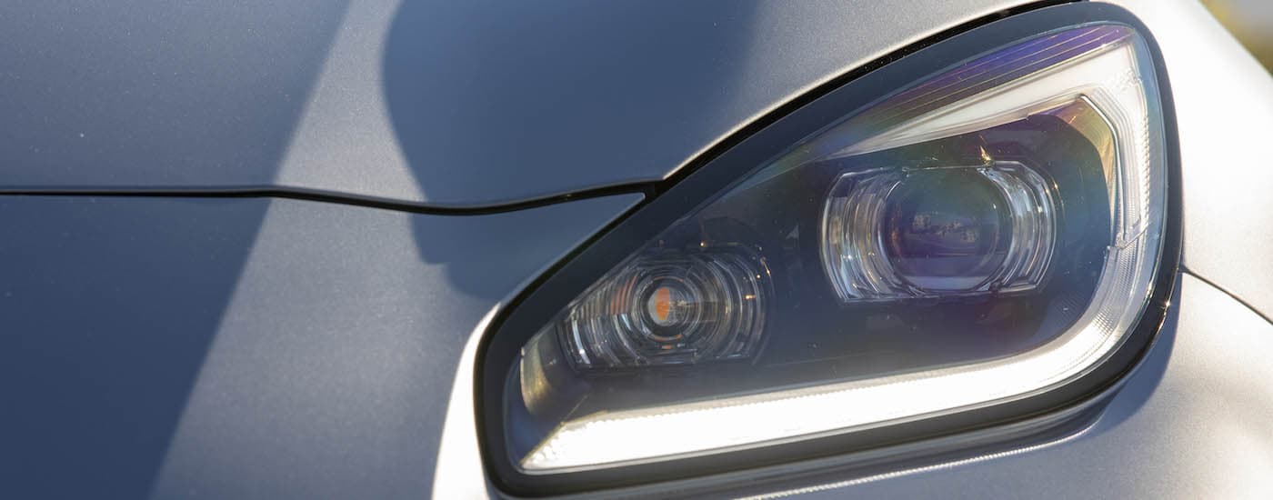 Close-up of the driver side headlight on a silver 2023 Subaru BRZ.