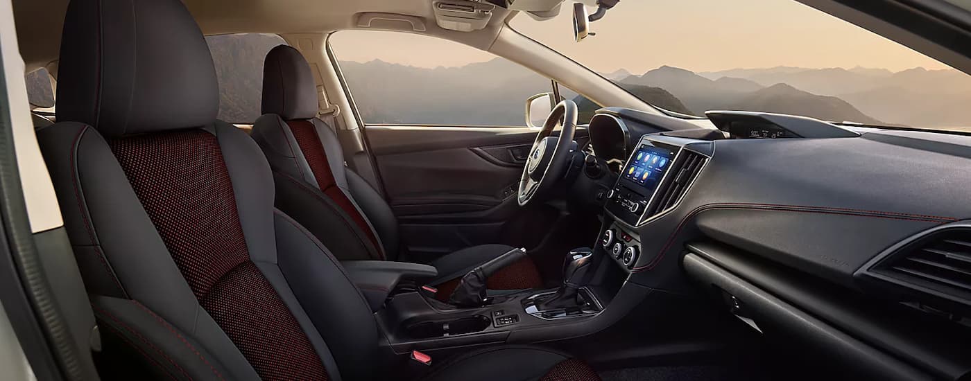 The maroon and black interior of a 2023 Subaru Crosstrek Special Edition parked in the mountains
