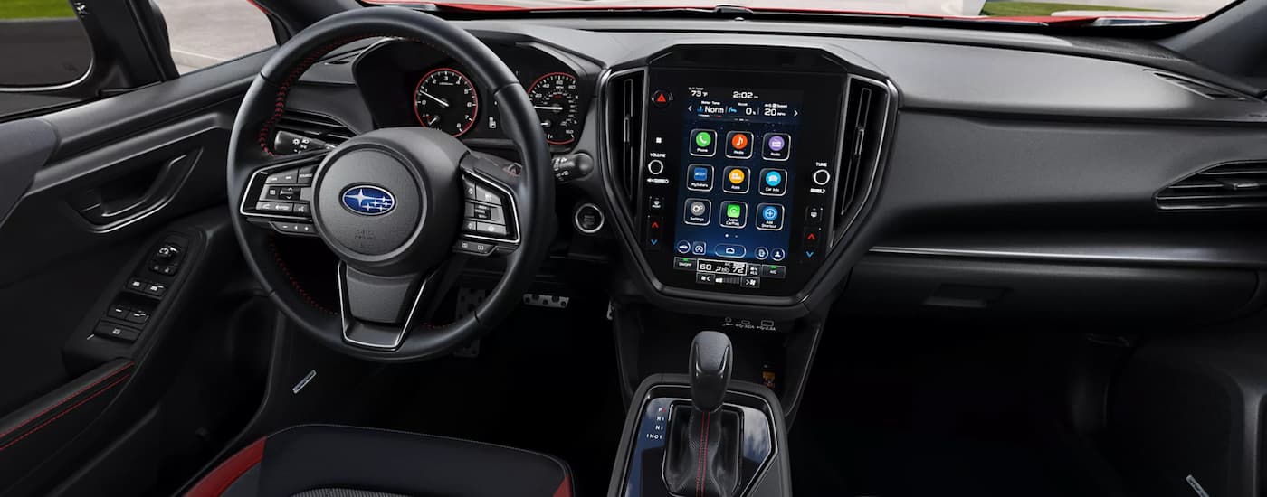 The black interior of a 2024 Subaru Impreza with the dash and infotainment screen