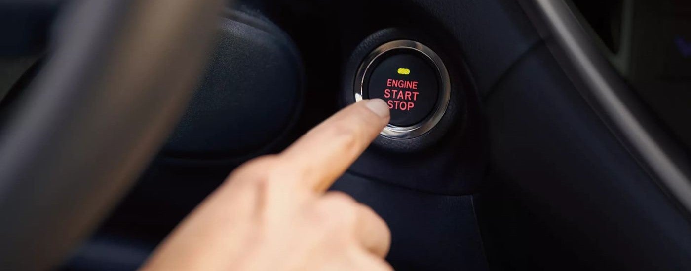 The ignition button is shown being pressed in a 2023 Subaru Ascent.