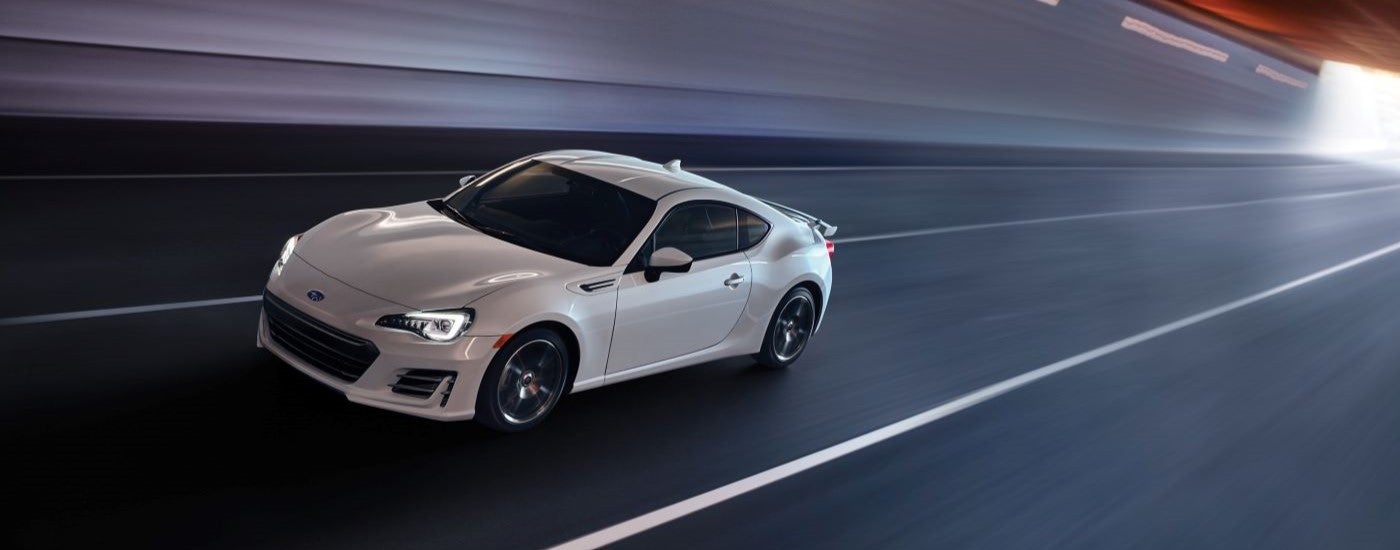 A white 2019 Subaru BRZ Premium is shown driving through a tunnel after looking at Subarus for sale near Gastonia.
